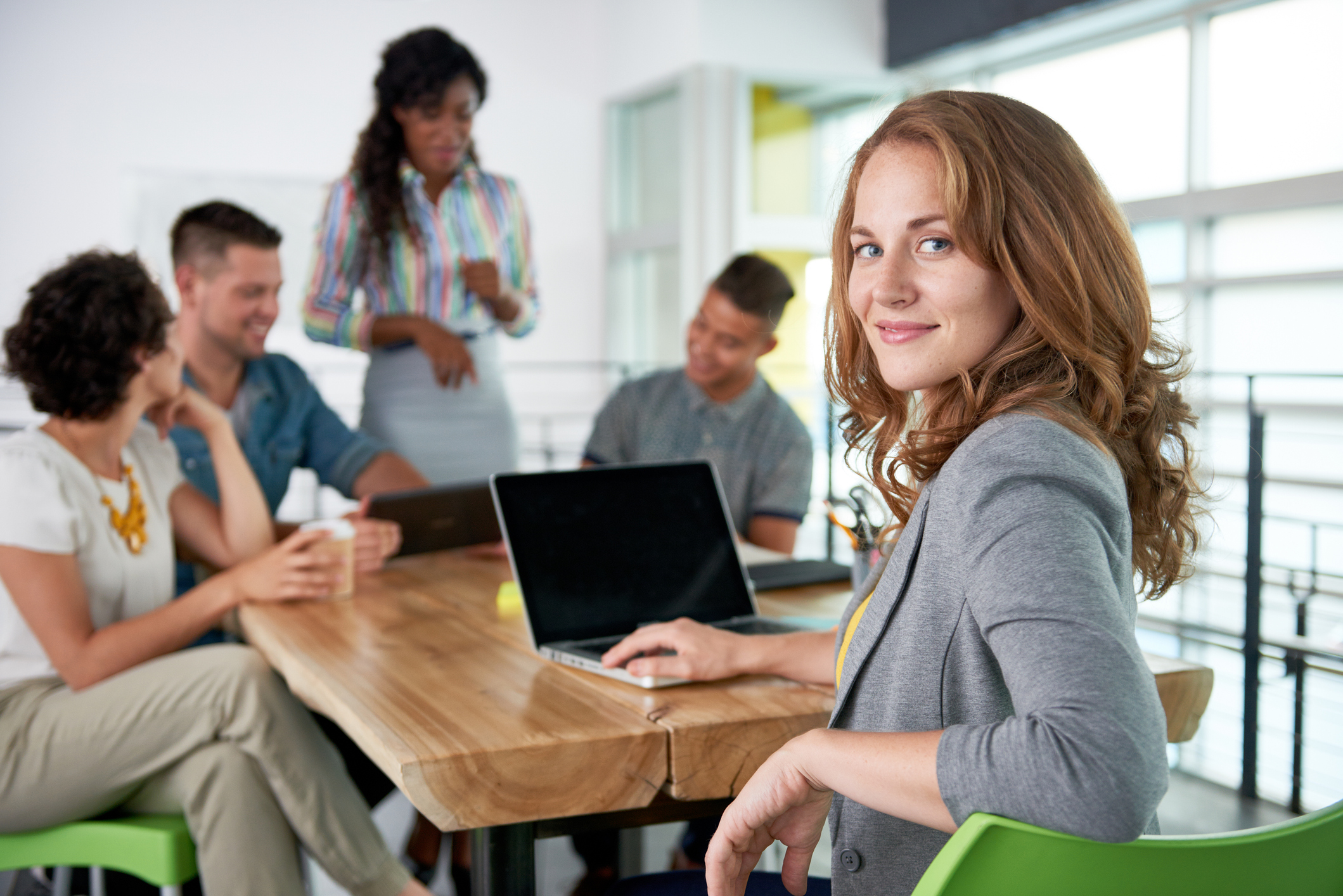 Image of a succesful casual business woman using laptop during