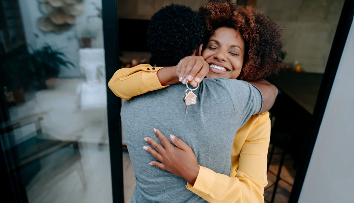 Ecstatic couple holding keys to new home